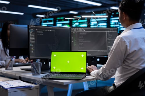 Preview: Programmers colleagues using mockup laptop to check server clusters