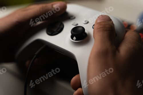 Preview: Closeup shot of a white XBOX controller in hands