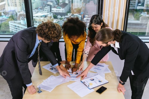 Preview: Diverse colleagues gather in brainstorm discuss statistics together.
