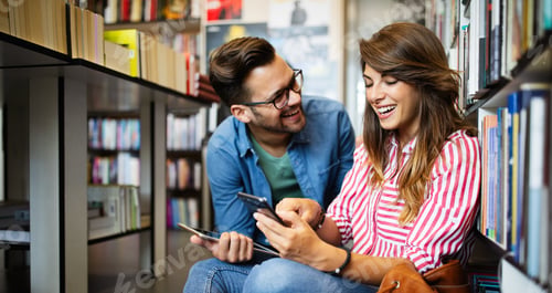Preview: Happy beautiful hipster love student couple taking a selfie in school library