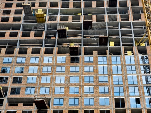 Preview: Facade of modern high building and process of installing windows