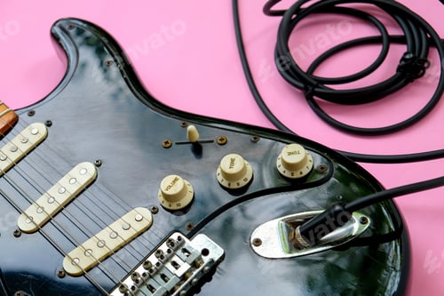 Preview: Electric guitar with cable on pink background