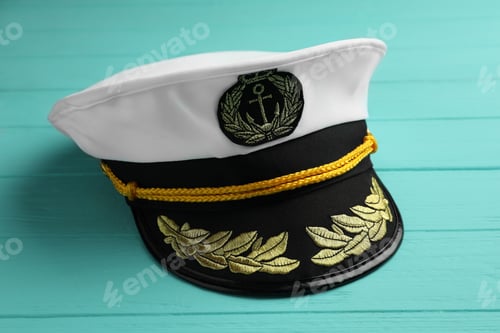 Preview: Peaked cap with accessories on turquoise wooden background