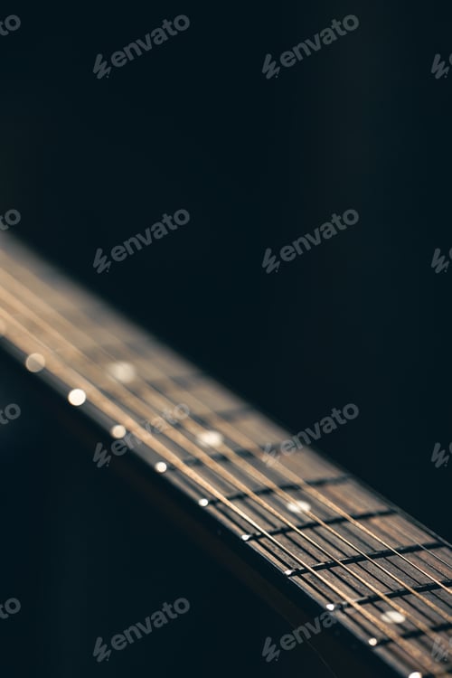 Preview: Part of an acoustic guitar, guitar fretboard on a black background.