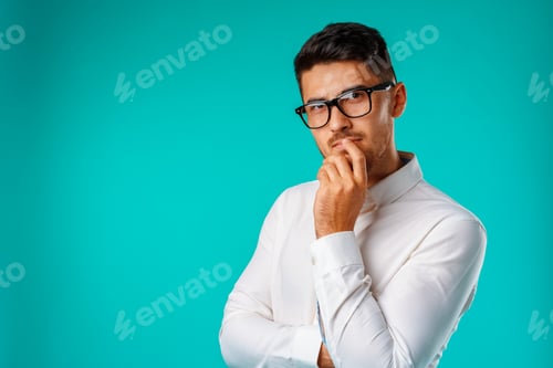 Preview: Photo of thoughtful young man touching his chin