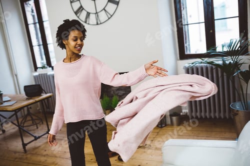 Preview: Woman coming home, throwing coat on sofa, smiling