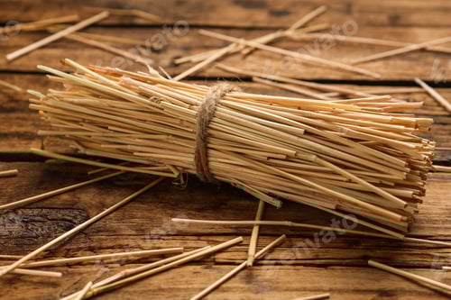 Preview: Sheaf of dried hay on wooden background, closeup