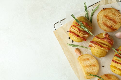 Preview: Concept of tasty food with baked potato on white textured background