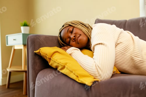 Preview: tired latin hispanic woman taking nap on the sofa during the day