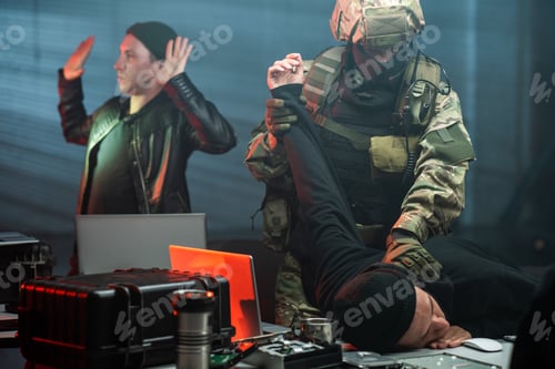 Preview: Man in military outfit taking cyber criminal at crime scene