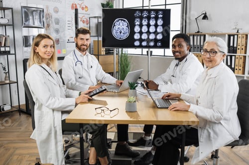 Preview: Portrait of healthcare team sitting at table in hospital
