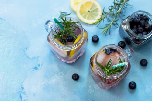 Preview: Lemonade or cocktail with blueberries and rosemary.