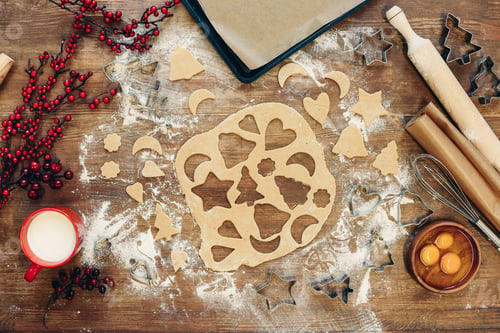 Preview: top view of unbaked dough for christmas cookies on wooden table