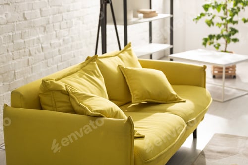 Preview: Comfortable yellow sofa with sunlight in living room