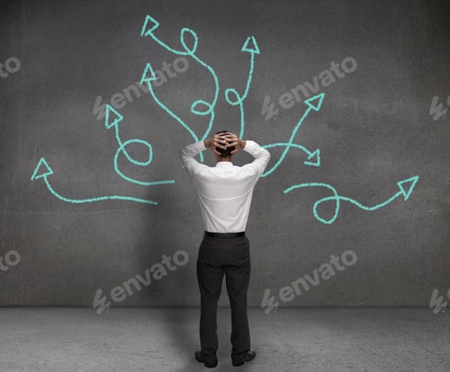 Preview: Stressed Businessman Looking At Arrows Drawn On A Wall