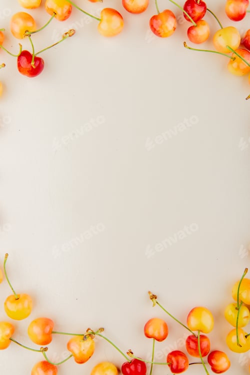 Preview: top view of cherries set in circular shape on white background with copy space