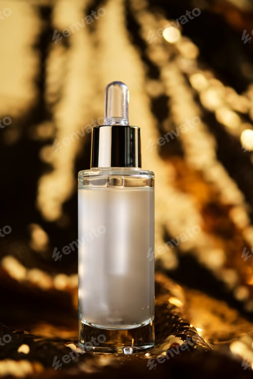 Preview: A bottle of cosmetic serum with a pipette on a festive golden background.