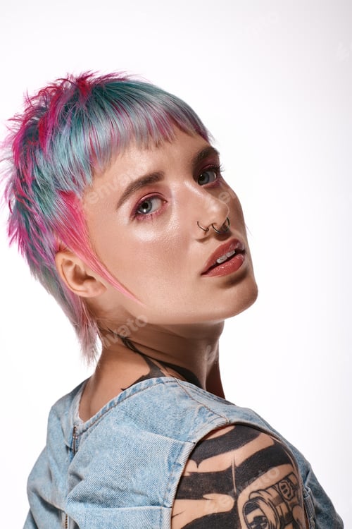 Preview: Young woman with colorful hair showcasing beauty in a stylish studio setting