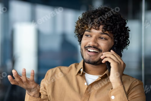 Preview: Close up portrait of young businessman, man talking cheerfully and smiling friendly , hispanic man