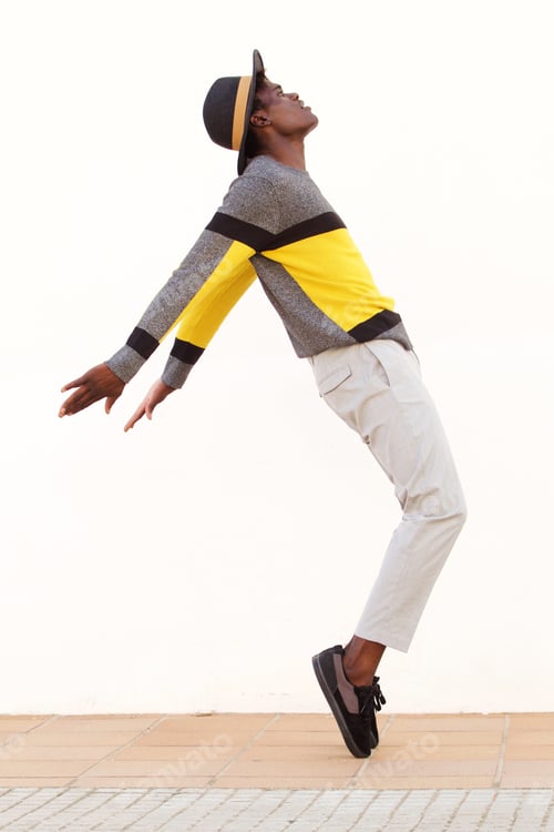 Preview: Full length african male dancer standing on his tip toes making a cool dance pose