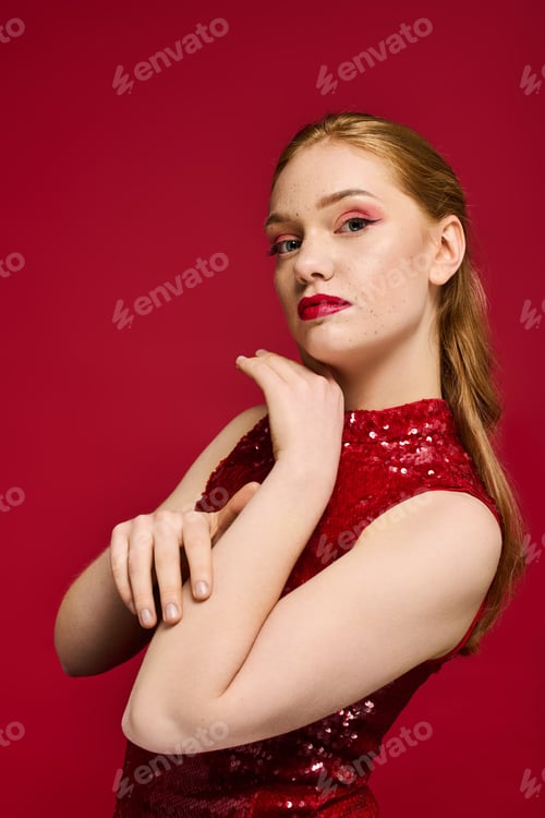 Preview: Elegant young woman in red attire poses gracefully against a vibrant background