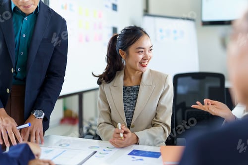 Preview: Asian businesspeople discussing and working together during a meeting