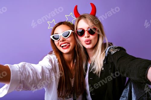 Preview: Young funny girls making selfie at studio making grimaces and going crazy