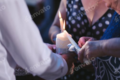 Preview: Wedding ceremony, paraphernalia, the bride and groom hold a large candle in their hand.