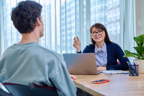 Preview: Guy student at therapy meeting with psychologist, mentor in college office