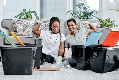 Preview: When in doubt dont throw it out. Shot of a young couple recycling their trash at home.