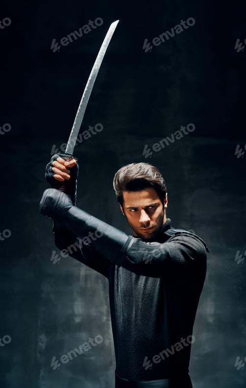 Preview: Warrior man posing with a sword ready to stab enemy
