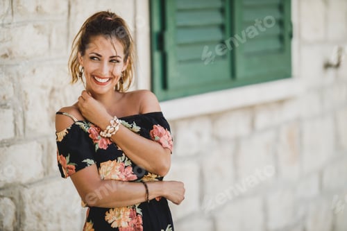 Preview: Smiling Woman in Floral Dress Posing Outdoors
