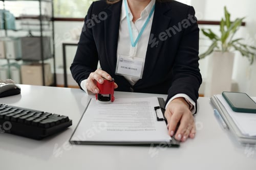 Preview: Social Worker Putting Stamp On Document