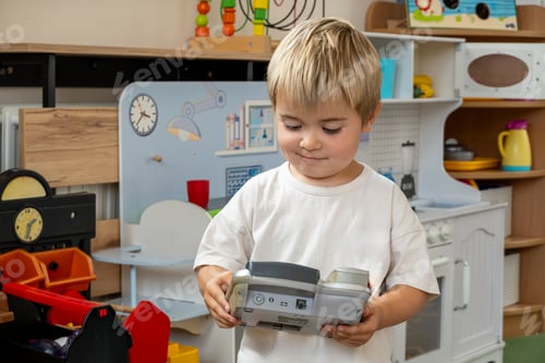 Preview: Child adaptation to kindergarten, smiling child plays with kindergarten toys