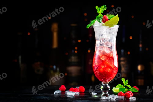 Preview: Raspberry lemonade cocktail or mocktail drink with raspberries, syrup, soda, lime, mint and ice