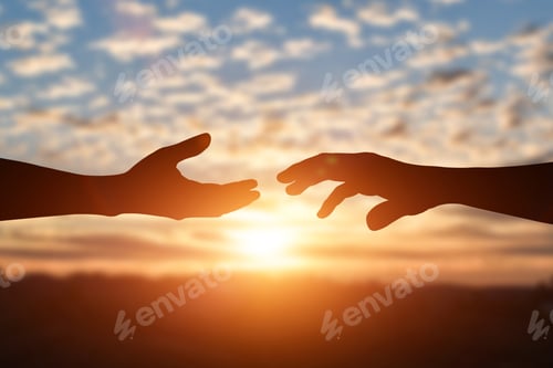 Preview: Silhouette of reaching, giving a helping hand, hope and support each other over sunset background.