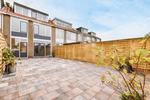 Suburban Home With Paved Yard and Wooden Fence
