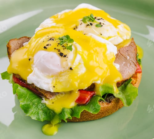 Preview: Tasty egg Benedict on green plate