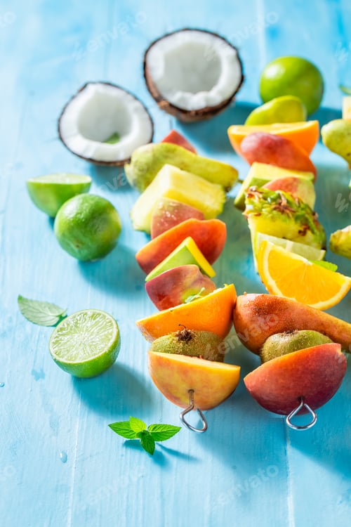 Preview: Fresh Tropical Fruit Skewers on Blue Wood