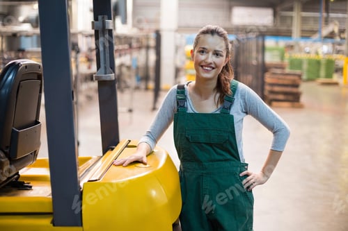 Preview: Female factory worker standing at drinks production factory