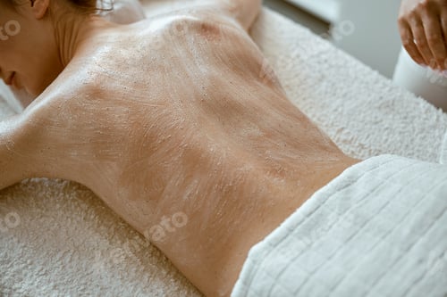 Preview: specialist is doing relaxing body massage for beautiful caucasian lady at minimalistic spa salon
