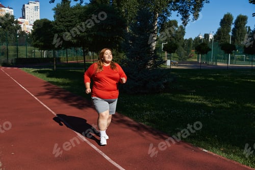 Preview: Plus size woman jogging in a vibrant park on a sunny day