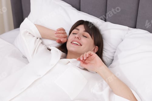 Preview: Beautiful woman sleeping in bed at home
