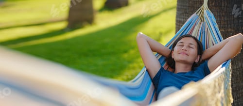 Preview: Woman Relaxing in Hammock in a Green Space