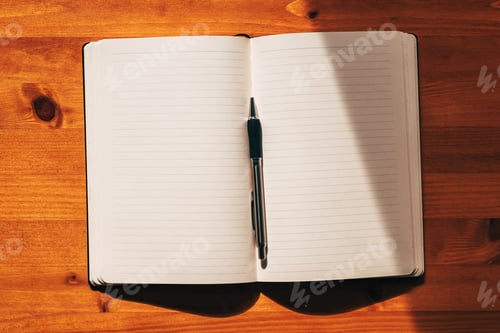 Preview: Journal or diary with blank mockup pages and a pen on the desk