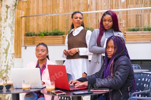 Preview: Young businesswomen of black ethnicity. In a business meeting in a cafeteria