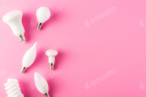 Preview: top view of various types of light bulbs on pink background