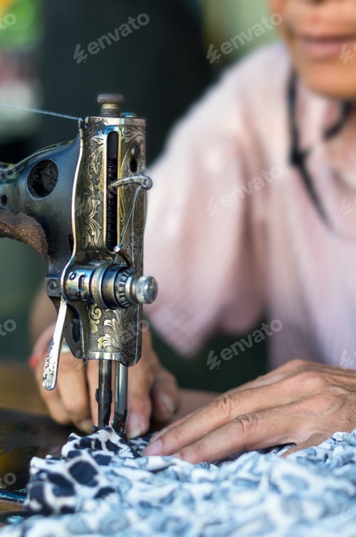 Preview: Sewing Process by hand with old man designer blur background