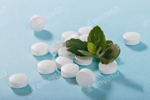 Preview: Herbal and Vitamin white pills healthy food with green leaves