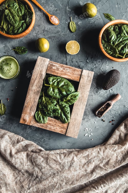 Preview: Spinach in a wooden box. Healthy food concept. Wooden plates, on a dark gray background.